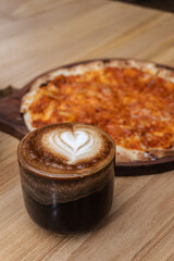 Hot latte coffee in wooden cup on cafe table. Hot drink. Beverages. Coffee latte. 