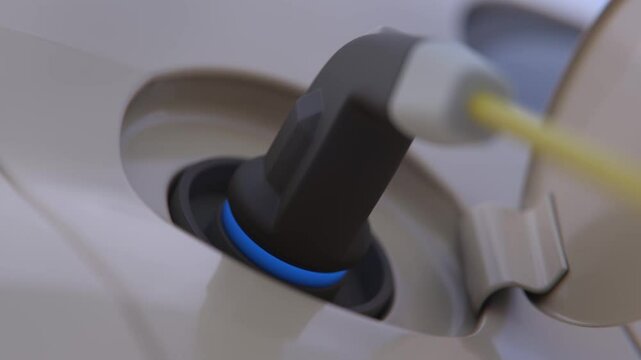 EV charger plug into electric car, Charging technology, Сharging electric car. Electric car charging at a charging station