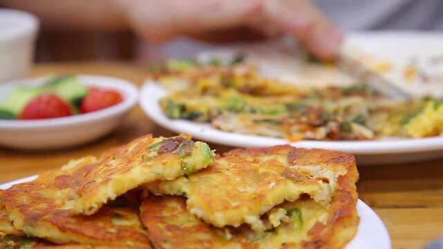 Mung bean pancake being picked up with chopsticks