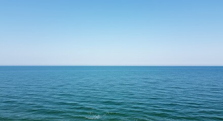 Obraz premium Calm blue ocean water surface with minimal ripple pattern for a calming background or abstract concept of tranquility and peace in nature for website backdrop