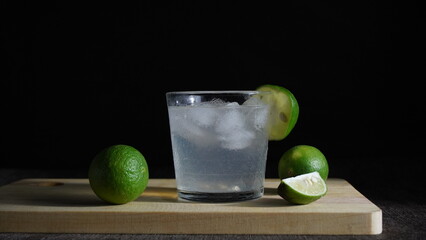 Ice water and lime on a wooden cutting board