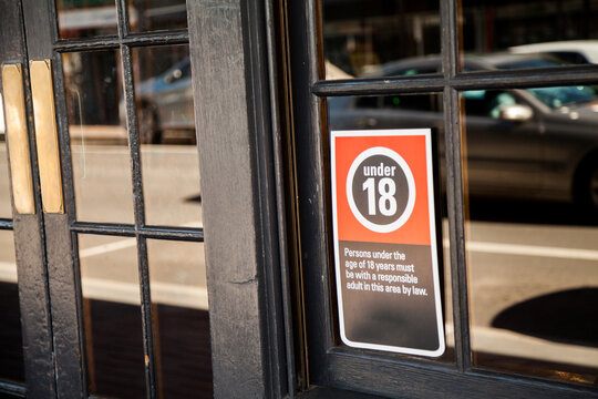Under 18 sign outside pub window