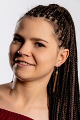 An Expressive Portrait of a Young Woman with Beautiful Braids Smiling Radiantly and Joyfully