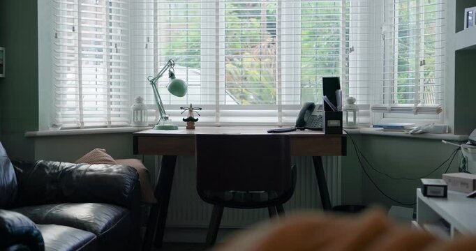 Home office, desk and empty room for cozy work space for freelance career, relax sofa or apartment job. Lounge, couch and table for entrepreneur at window for business call, online startup or remote