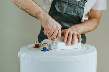 Technician repairing electric water heater system