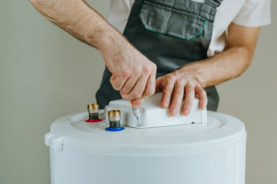 Technician repairing electric water heater system