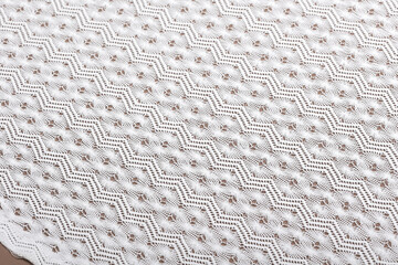 White bridal lace on skin color background. Flatlay featuring bridal textile ideal for wedding creations, with soft white lace.