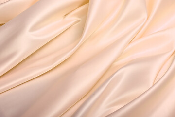 Close-up of luxurious beige American satin, known for its stiffness and elegant sheen. A premium...