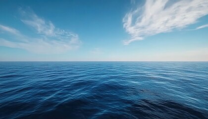 Fototapeta premium Calm sea under a blue sky with white clouds in horizontal composition.