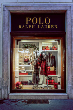 Show window of Polo Ralph Lauren fashion store, decorated in Christmas style with bright golden lights. Boutique shop in Rome, Italy