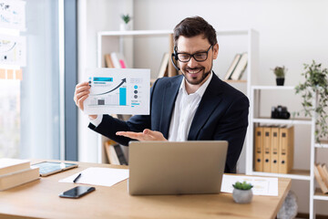 Young adult man presenting data charts during virtual business meeting, professional remote communication.