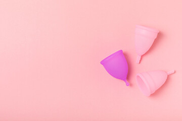 Menstrual cup on a bright background. Sanitary napkins, tampons and menstrual cup.Concept of critical days, menstruation.feminine hygiene product. Women health concept.Premenstrual syndrome.Copy space