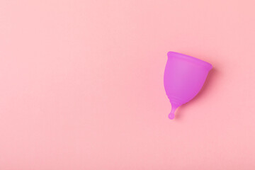 Menstrual cup on a bright background. Sanitary napkins, tampons and menstrual cup.Concept of...