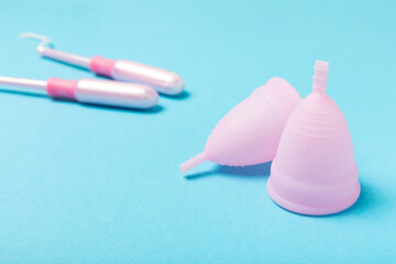 Menstrual cup on a bright background. Sanitary napkins, tampons and menstrual cup.Concept of...