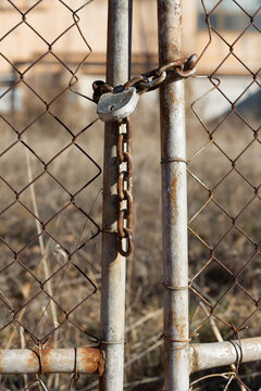 Chain and padlock on metal gate