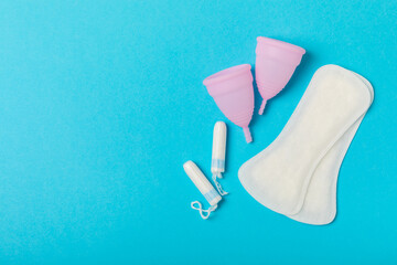 Menstrual cup on a bright background. Sanitary napkins, tampons and menstrual cup.Concept of...