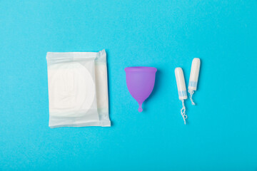 Menstrual cup on a bright background. Sanitary napkins, tampons and menstrual cup.Concept of...