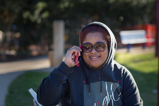 Woman in park listening on phone