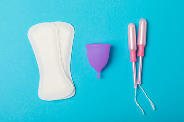 Menstrual cup on a bright background. Sanitary napkins, tampons and menstrual cup.Concept of...
