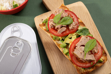 Tuna sandwiches on a table next to lemonade and beer, in a modern interior design