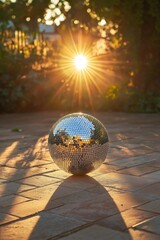 Fototapeta premium Disco ball reflecting sunlight on tiled surface during sunset