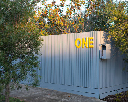 House fence with the number one one it in letters and numbers
