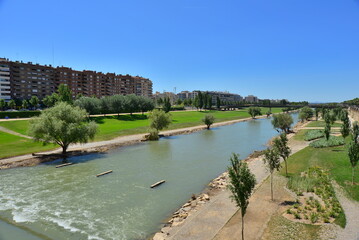 River Segre grown as it passes through Lleida at the beginning of summer