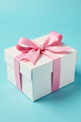 Fototapeta premium Feminine gift box with pastel pink bow on pale blue background, pastel colors, elegant, luxury