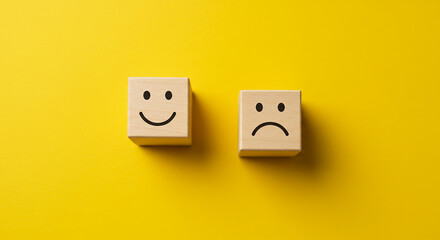 Happy sad emotion blocks isolated on bright yellow surface for customer satisfaction or review symbol