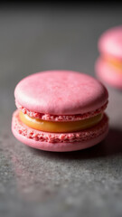 Fototapeta premium A close-up of a single macaron with a perfect filling, placed on a textured surface