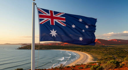 Australian flag waving in the wind with a beautiful beach and landscape in the background, national symbol of Australia, travel and tourism concept.