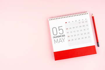 Fototapeta na wymiar May 2025 desk calendar and red pencil, Position with copy space.