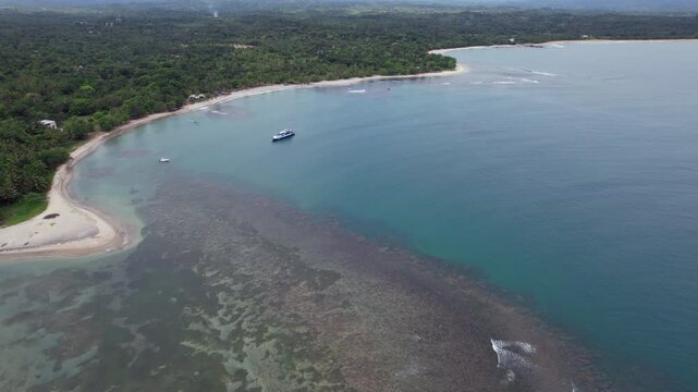Drone glides over Mahambo&rsquo;s reef shoreline, advancing toward the Ferry El Condor as it prepares for its voyage to the idyllic island of &Icirc;le Sainte-Marie.