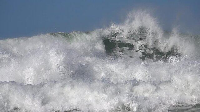 Ocean sea big wave splashing. foam fizz. Blue sky