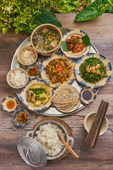 Traditional Vietnamese Food in wooden table with Green background

