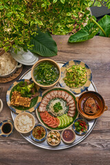 Traditional Vietnamese Food in wooden table with Green background
