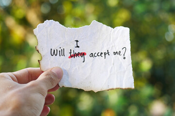 hand holding a note paper with the words Will They Accept Me? replacing Will I Accept Me? A deep reflection on inner acceptance, personal identity, emotional growth, and the courage to embrace oneself