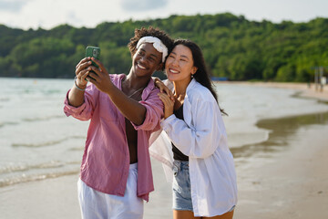 Passionate summer love on a tropical beach, young interracial couple enjoying adventure, laughter