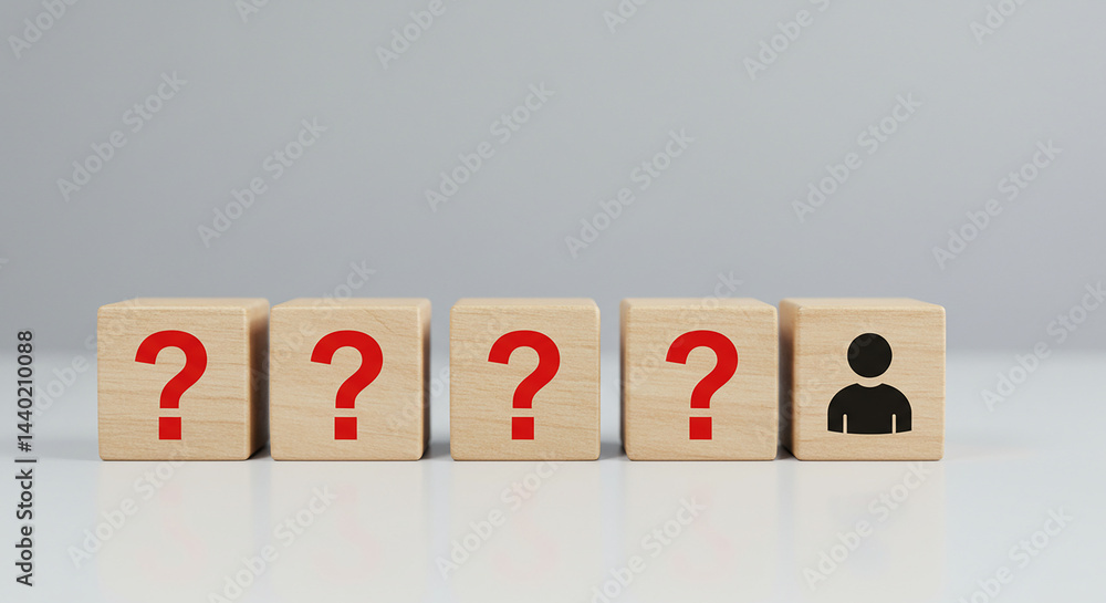 Poster wooden blocks showing question marks and a person icon against a plain background on a white surface