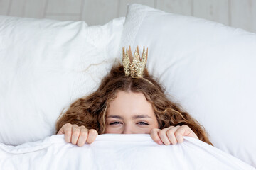 Woman sleeping. High angle view of beautiful young woman lying in bed covered with blanket. Young...