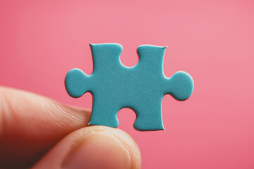 Obraz premium A hand holding a blue puzzle piece, macro photography, stock photo, pink background, hyperrealistic.