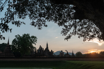 Ancient ruins of old Buddhist temple in Sukhothai Historical Park Thailand with weathered stone...