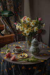Beautiful bouquet of narcissus with teapot