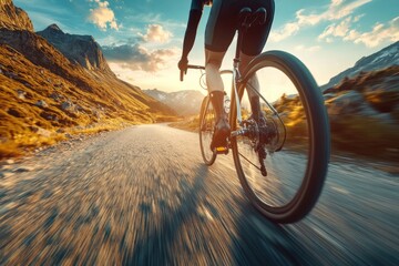 Professional cyclist speeding downhill on a mountain road during golden hour