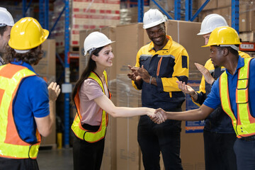 Female worker shaking hands at team celebrating. Teamwork and camaraderie after finishing...