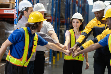 Group of warehouse workers Join hands each other, showing teamwork and camaraderie after finishing...