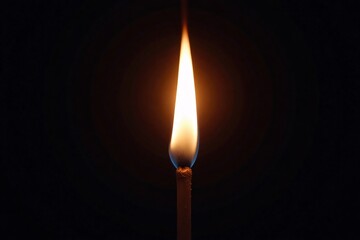 Burning matchstick bright flame in dark background minimalist stock photo