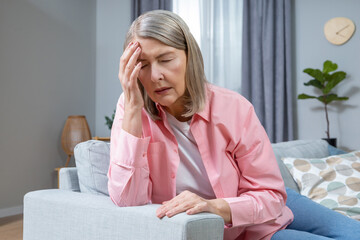 Mid aged woman suffering from a headache and looking exhausted