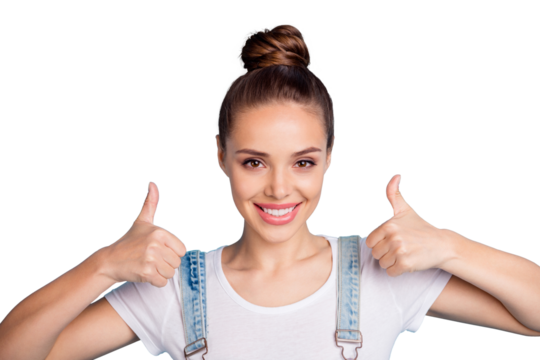 Close up photo of lovely girl showing thumb up smiling wearing white t-shirt denim jeans overalls isolated over blue background