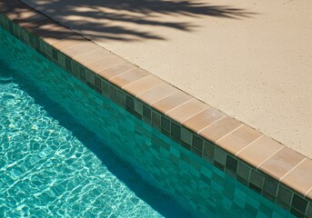 Sparkling turquoise pool water meets warm beige tile coping a summer paradise